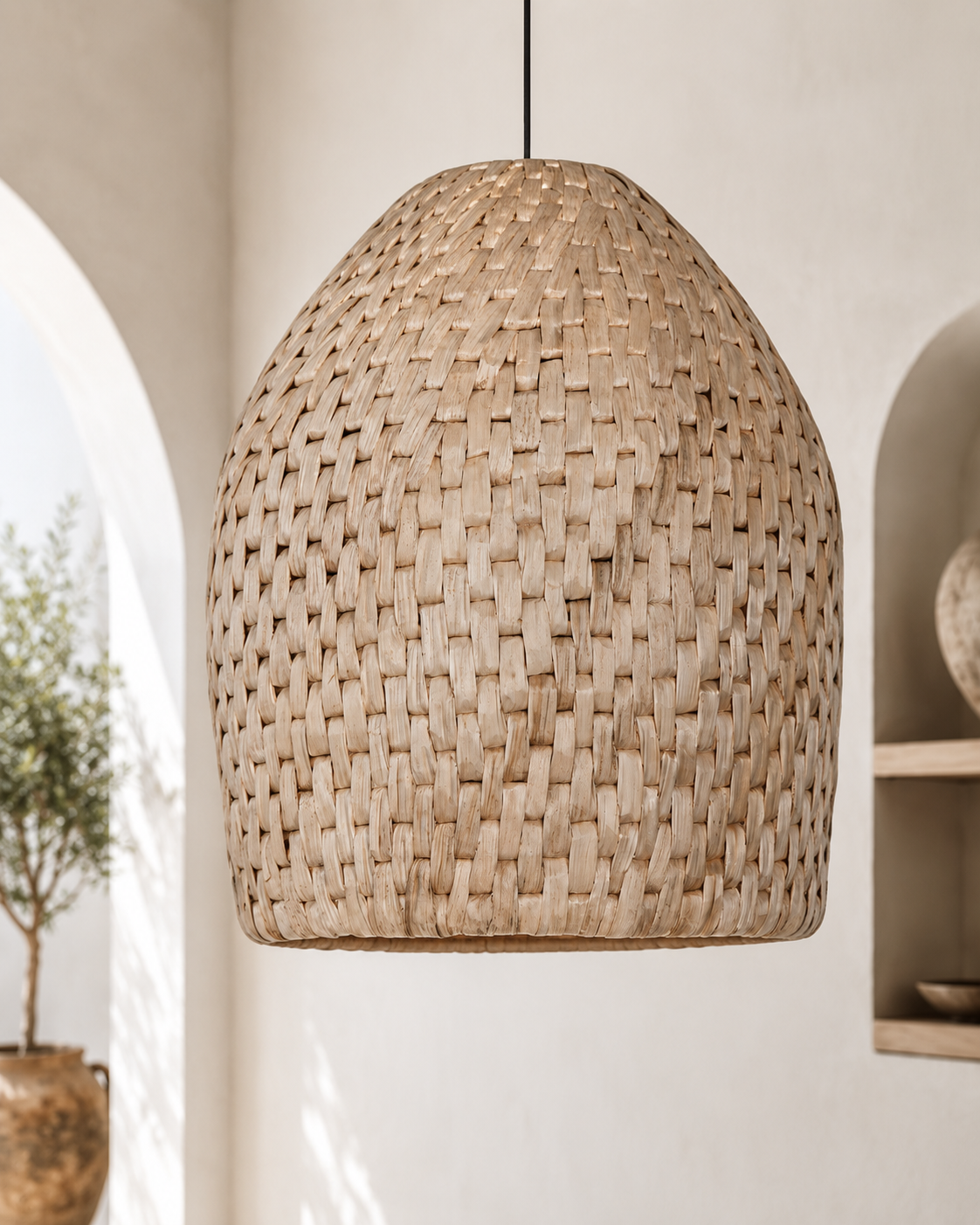 Woven pendant light hanging in a room with neutral decor