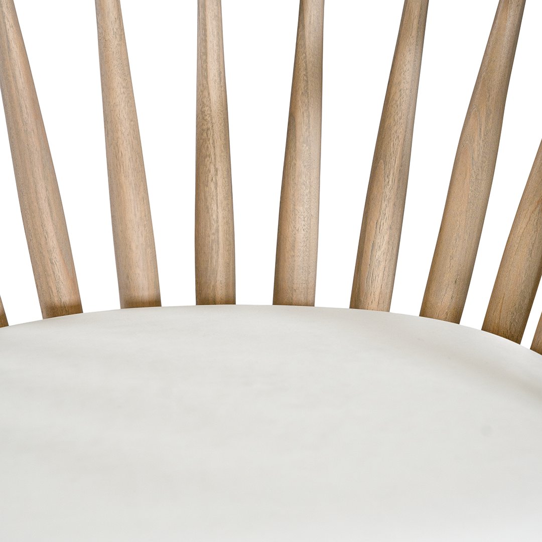 Lightwood spindle dining chair with a curved backrest and white upholstered seat, showcasing a modern yet timeless design. Crafted from solid wood, this chair brings a refined, natural aesthetic to any dining or living space