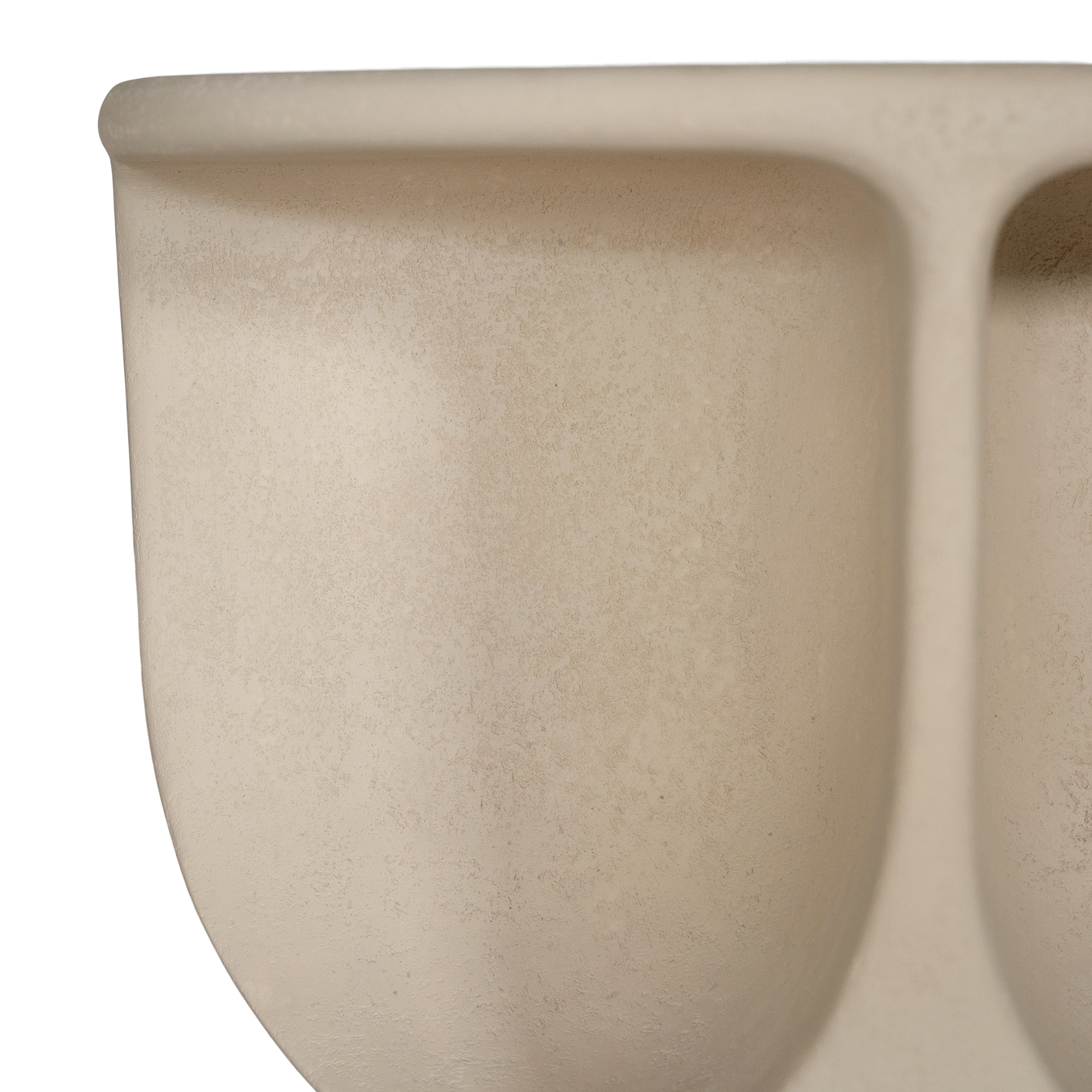 Berber coffee table in driftstone finish featuring sculptural curved legs and a softly rounded top with a textured natural surface.