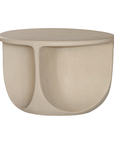 Berber coffee table in driftstone finish featuring sculptural curved legs and a softly rounded top with a textured natural surface.