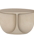Berber coffee table in driftstone finish featuring sculptural curved legs and a softly rounded top with a textured natural surface.