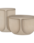Berber side and coffee table in driftstone finish featuring sculptural curved legs and a softly rounded top with a textured natural surface.
