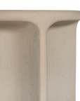 Berber side table in driftstone finish featuring sculptural curved legs and a softly rounded top with a textured natural surface.
