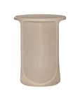 Berber side table in driftstone finish featuring sculptural curved legs and a softly rounded top with a textured natural surface.