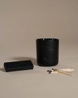 Kulala Living black candle set with minimalist branding, featuring a luxury soy wax candle in a matte black vessel, set against a neutral background for a refined and elegant aesthetic