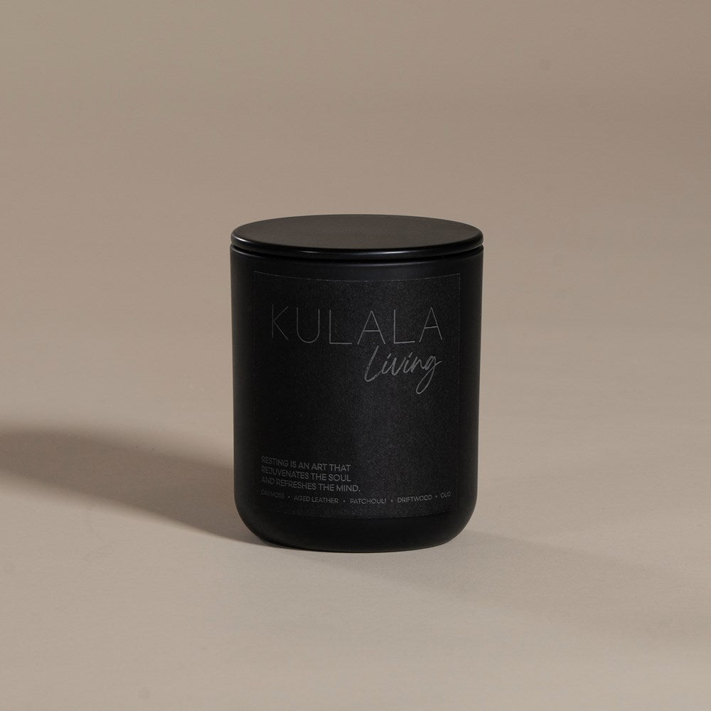 Kulala Living black candle with minimalist branding, featuring a luxury soy wax candle in matte black vessels, set against a neutral background for a refined and elegant aesthetic
