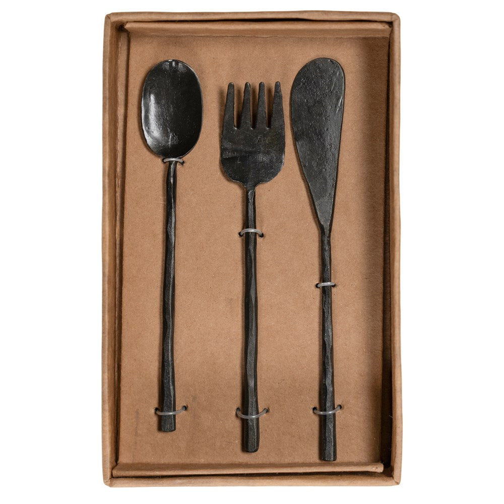 A set of three handcrafted black cutlery pieces from KULALA Living, including a spoon, fork, and knife, featuring a hand-forged finish with textured handles for a refined yet rustic dining aesthetic