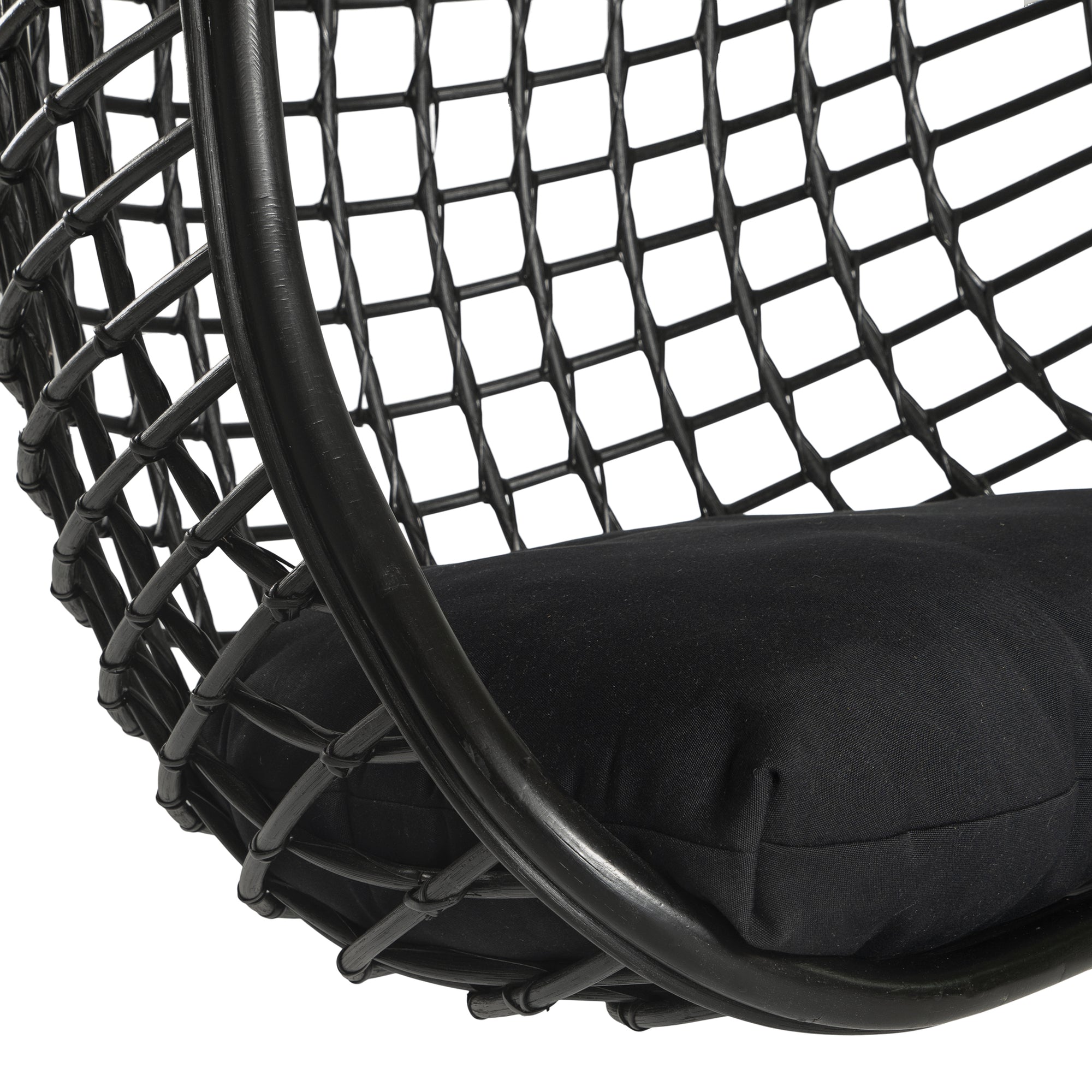 A stylish black hanging chair with an open-weave design, suspended by a natural rope and featuring a plush black cushion for ultimate relaxation