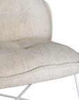 A modern natural lounge chair featuring a cushioned seat and backrest upholstered in textured linen fabric. Designed with a sleek metal frame, this chair offers a stylish and comfortable seating option for contemporary interiors