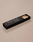 Kulala Living black matchbox with minimalist branding, featuring long wooden matches with black tips, set against a neutral backdrop for a refined aesthetic