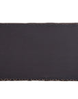 A black and natural handwoven bedhead featuring intricate geometric patterns, crafted from durable natural fibres for a timeless and earthy aesthetic