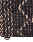 A black and natural handwoven bedhead featuring intricate geometric patterns, crafted from durable natural fibres for a timeless and earthy aesthetic
