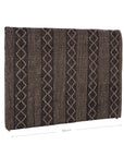 A black and natural handwoven bedhead featuring intricate geometric patterns, crafted from durable natural fibres for a timeless and earthy aesthetic