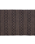 A black and natural handwoven bedhead featuring intricate geometric patterns, crafted from durable natural fibres for a timeless and earthy aesthetic