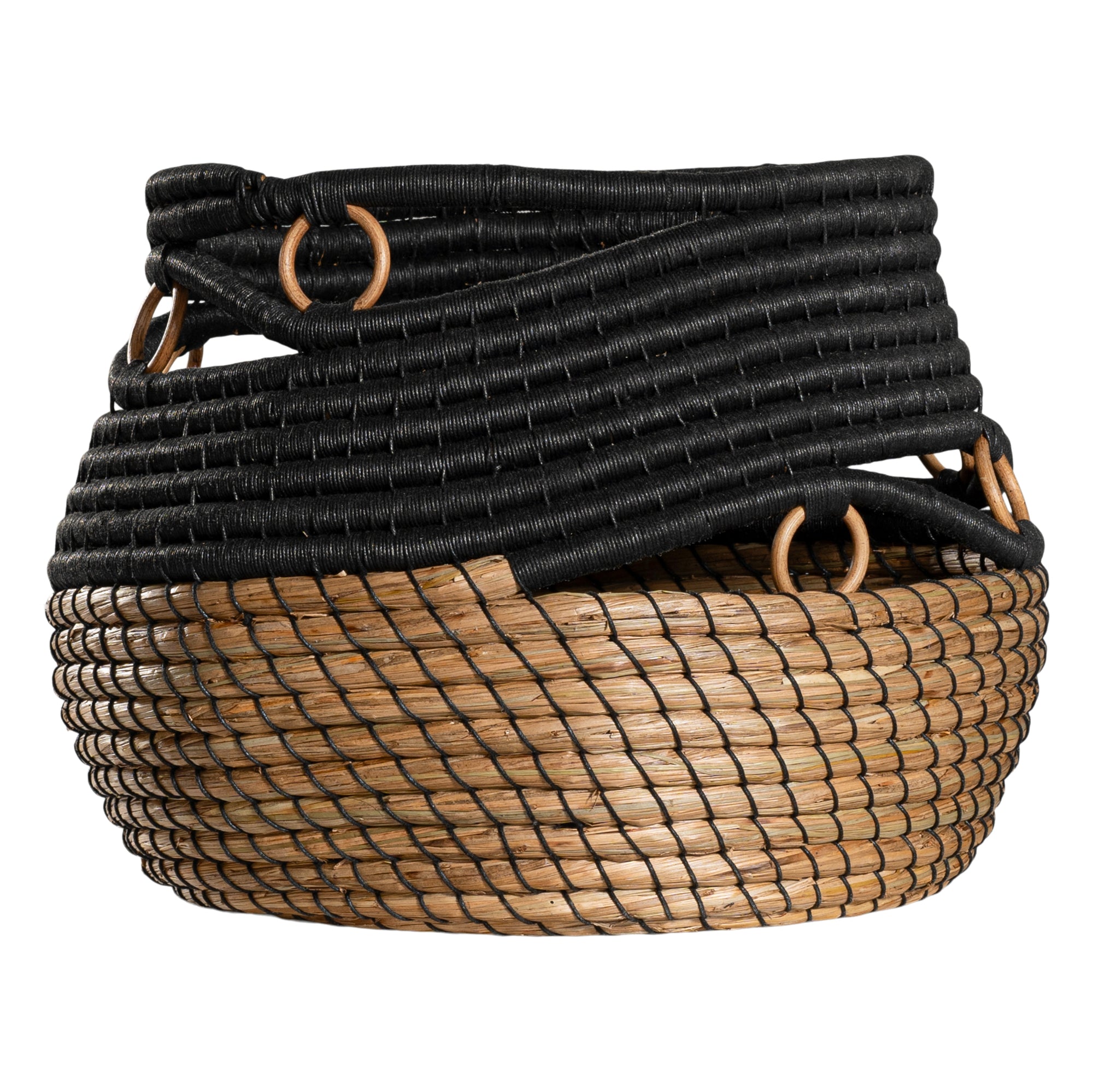 Black and natural woven basket with circular accents, ideal for decorative storage and adding texture to interior spaces.
