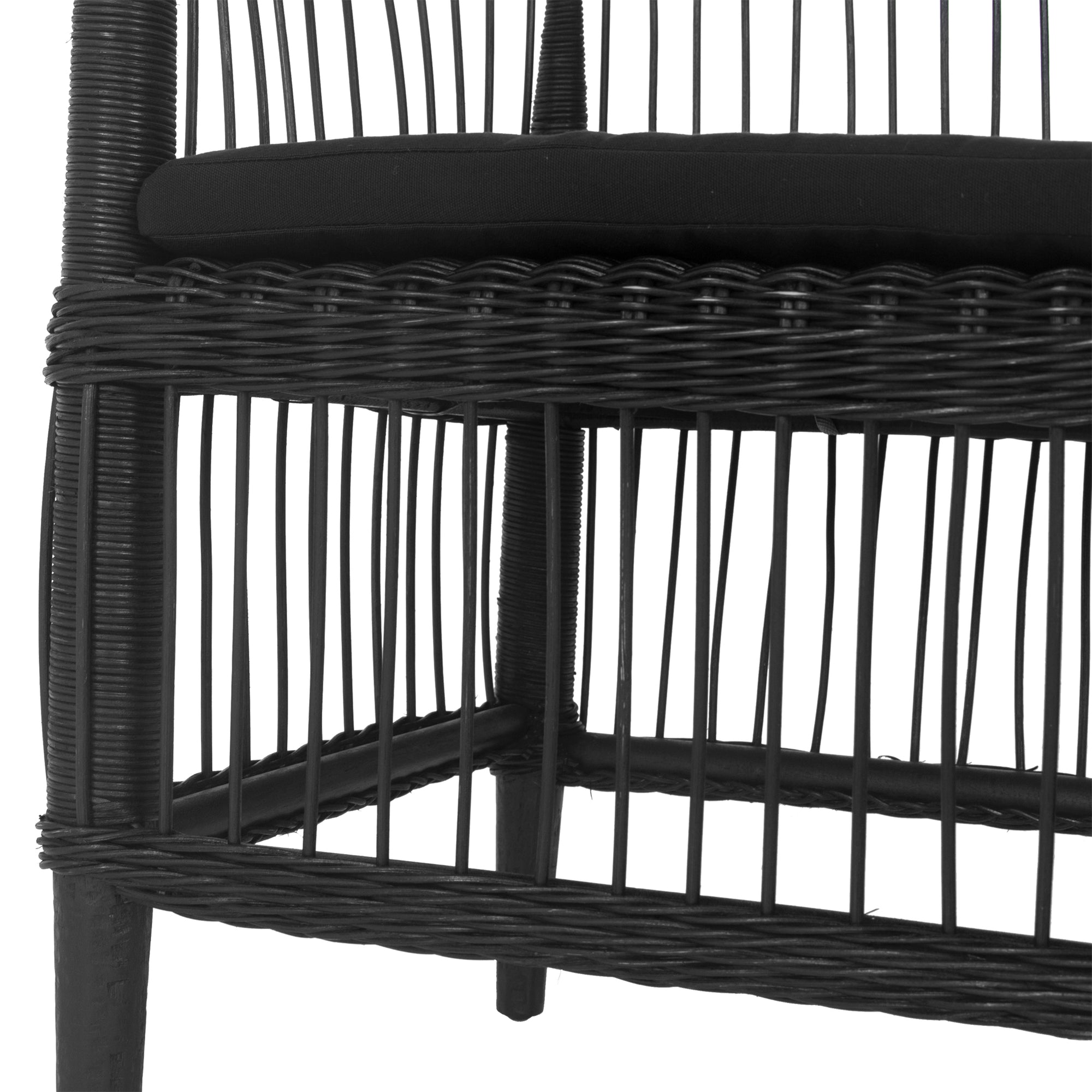 A stylish black rattan dining chair with an intricate woven design and a sleek black cushion, adding a modern touch to any dining or seating area