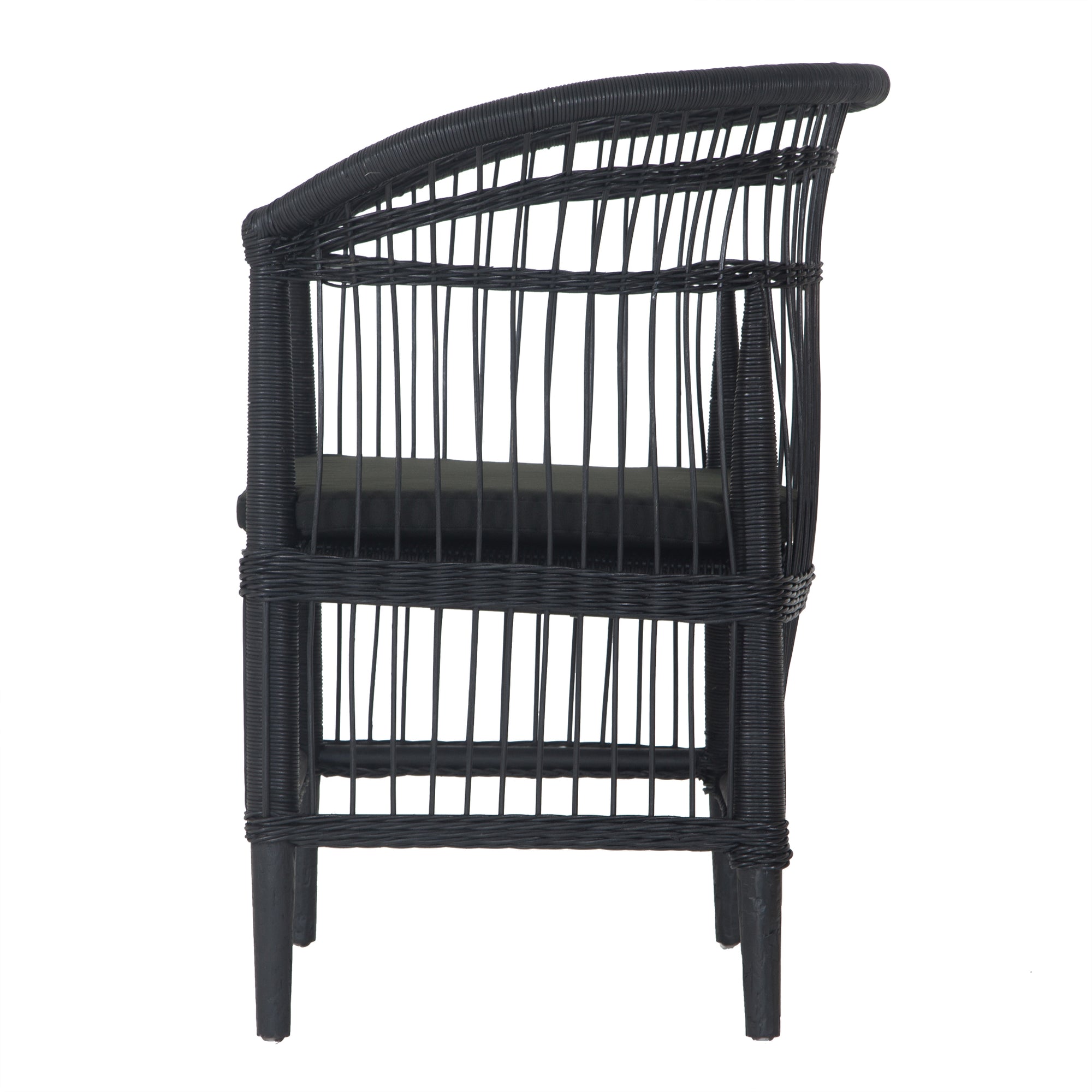 A stylish black rattan dining chair with an intricate woven design and a sleek black cushion, adding a modern touch to any dining or seating area