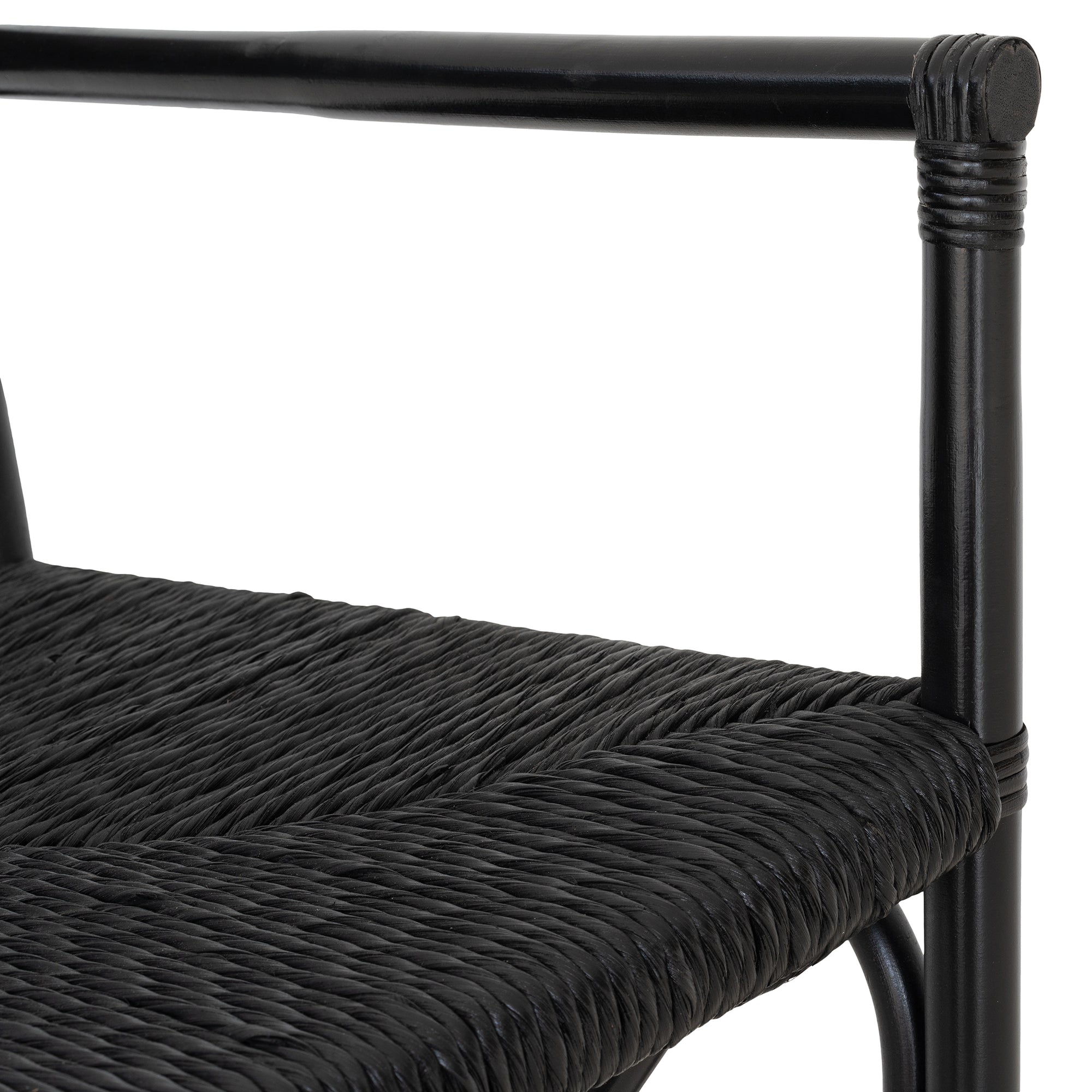 Black wicker armchair with armrests and a sturdy cross-frame base, showcasing a contemporary design suitable for indoor or outdoor dining spaces.