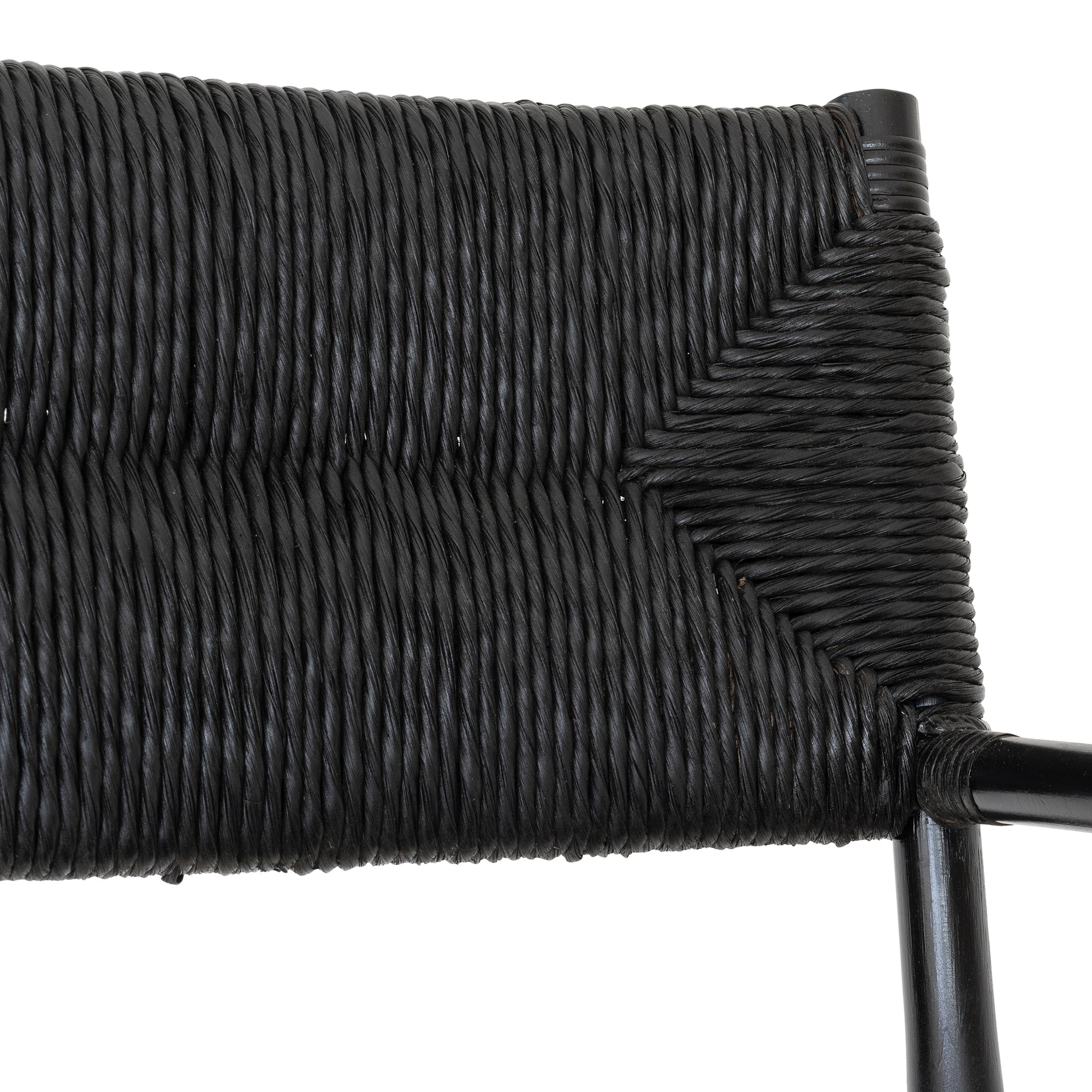 Black wicker armchair with armrests and a sturdy cross-frame base, showcasing a contemporary design suitable for indoor or outdoor dining spaces.