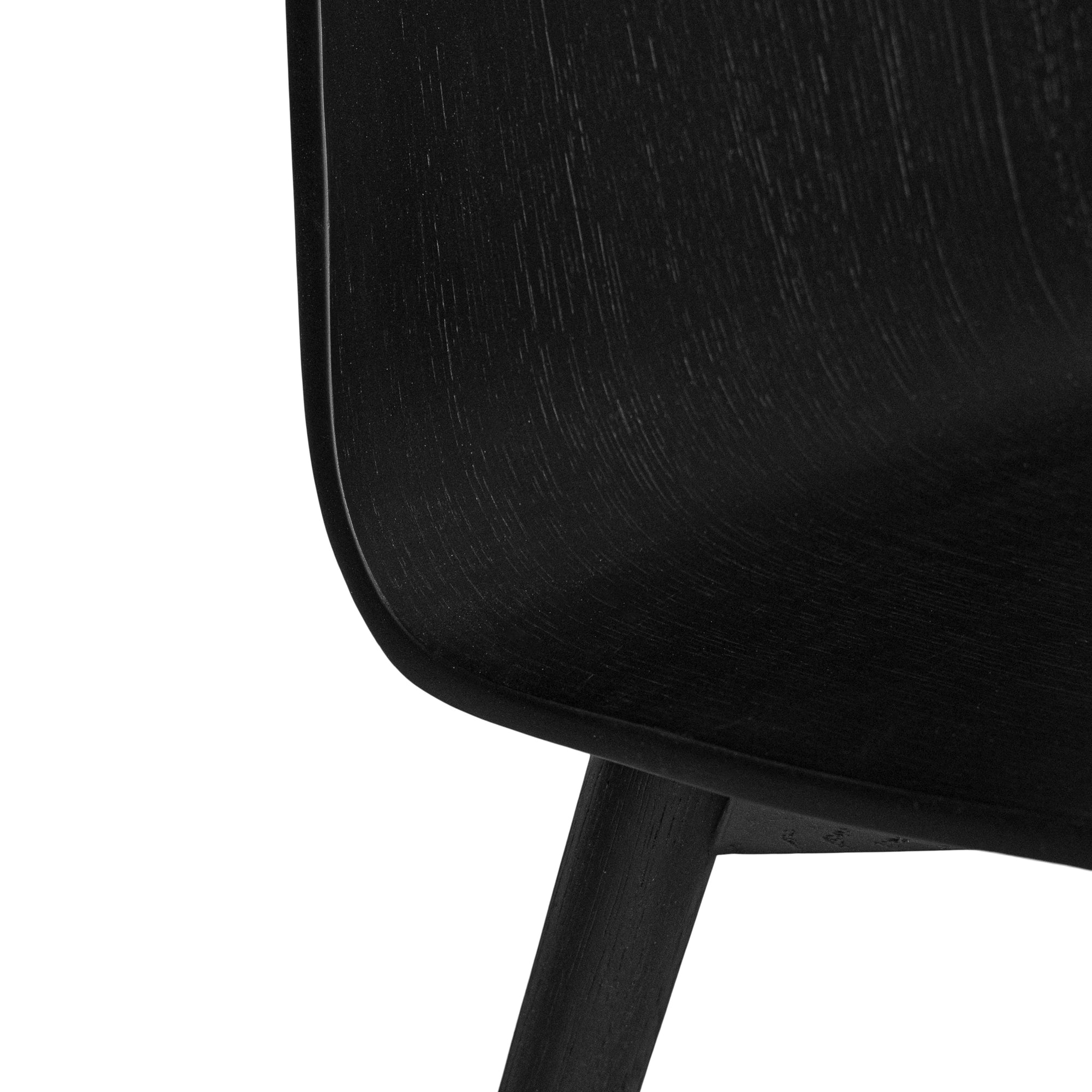 The Kulala Living black wood dining chair features a sleek, curved seat with a natural wood grain finish. Its minimalist design and sturdy legs make it a stylish and versatile addition to any modern dining space