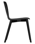 The Kulala Living black wood dining chair features a sleek, curved seat with a natural wood grain finish. Its minimalist design and sturdy legs make it a stylish and versatile addition to any modern dining space
