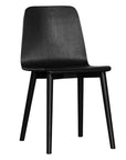 The Kulala Living black wood dining chair features a sleek, curved seat with a natural wood grain finish. Its minimalist design and sturdy legs make it a stylish and versatile addition to any modern dining space