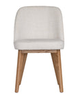 Elegant boucle dining chair with a curved upholstered backrest and plush cushioned seat, supported by tapered lightwood legs. A refined and comfortable seating option for modern dining spaces