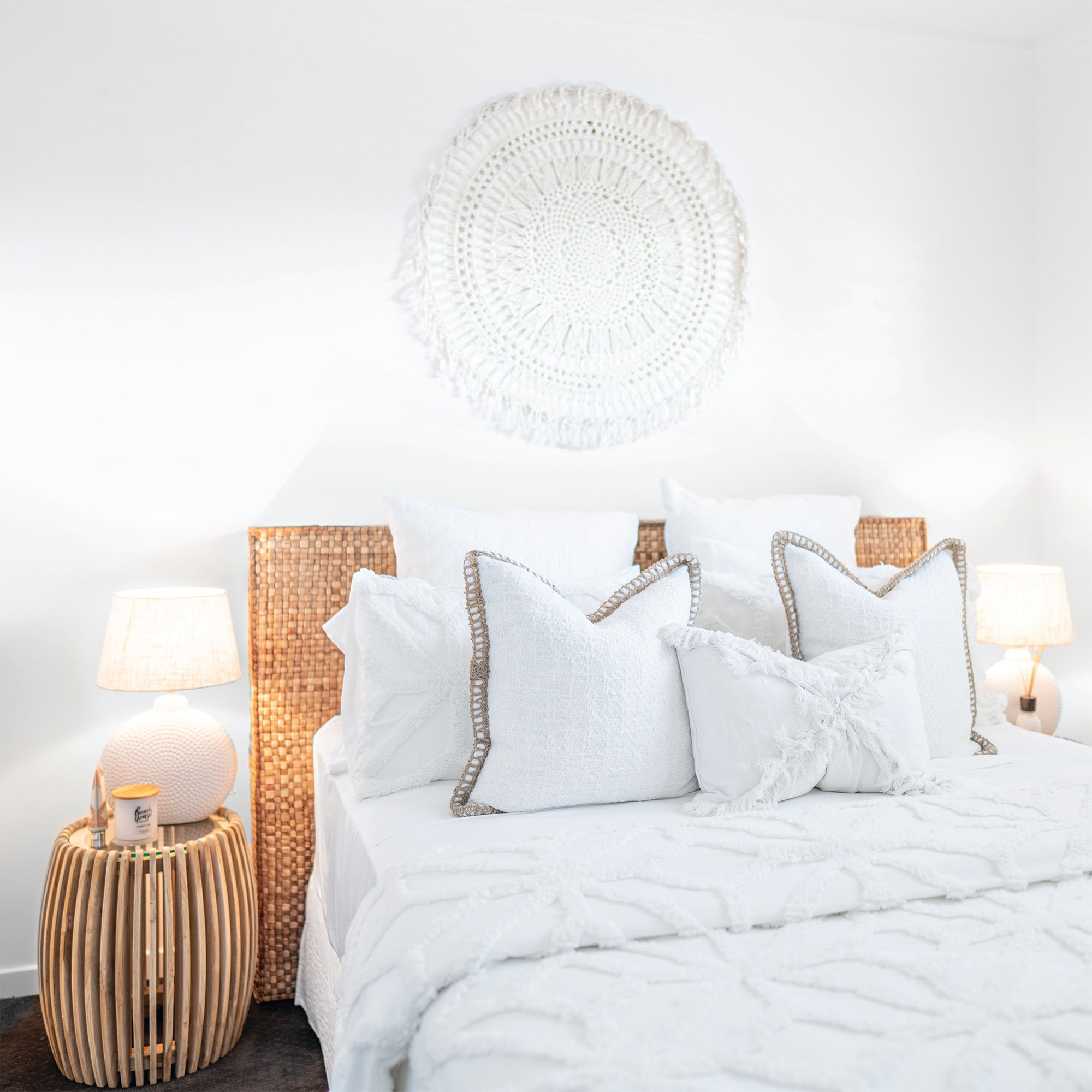 Natural white boho bedroom with a minimalist setting and teak side table.