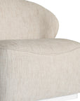 Coroo occasional chair in natural textured fabric with a soft curved backrest and rounded silhouette on a low plinth base.