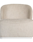 Coroo occasional chair in natural textured fabric with a soft curved backrest and rounded silhouette on a low plinth base.