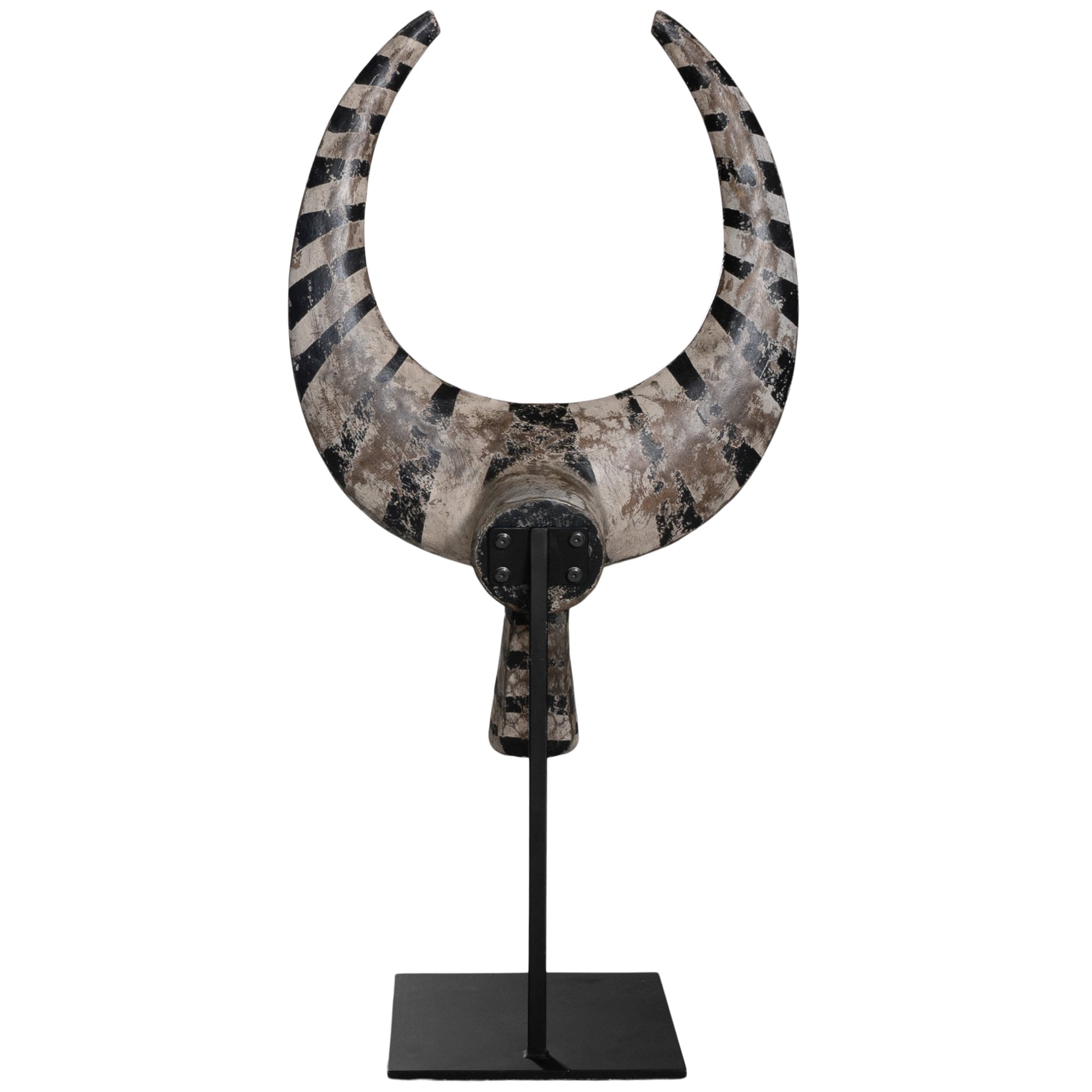 A striking decorative tribal horn sculpture with bold black and natural tones, mounted on a sleek black stand, adding an artisanal touch to modern interiors.