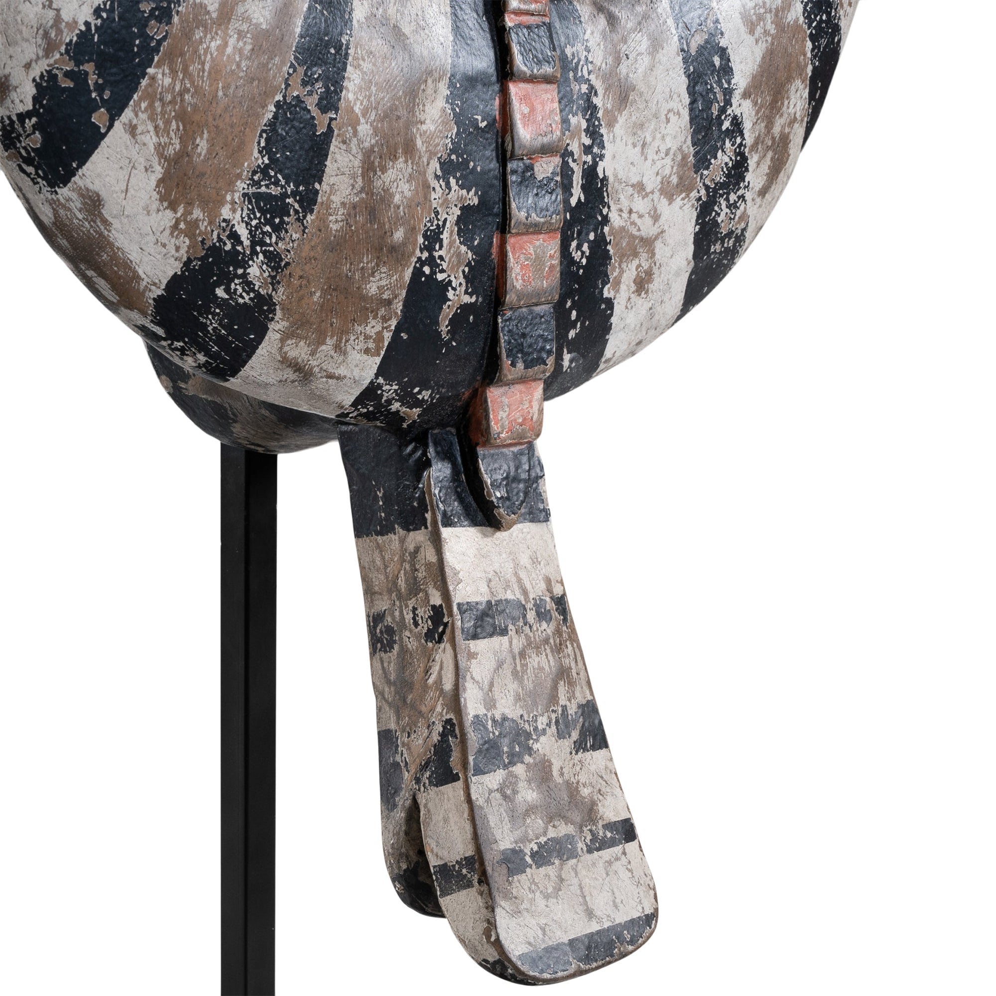 A striking decorative tribal horn sculpture with bold black and natural tones, mounted on a sleek black stand, adding an artisanal touch to modern interiors.