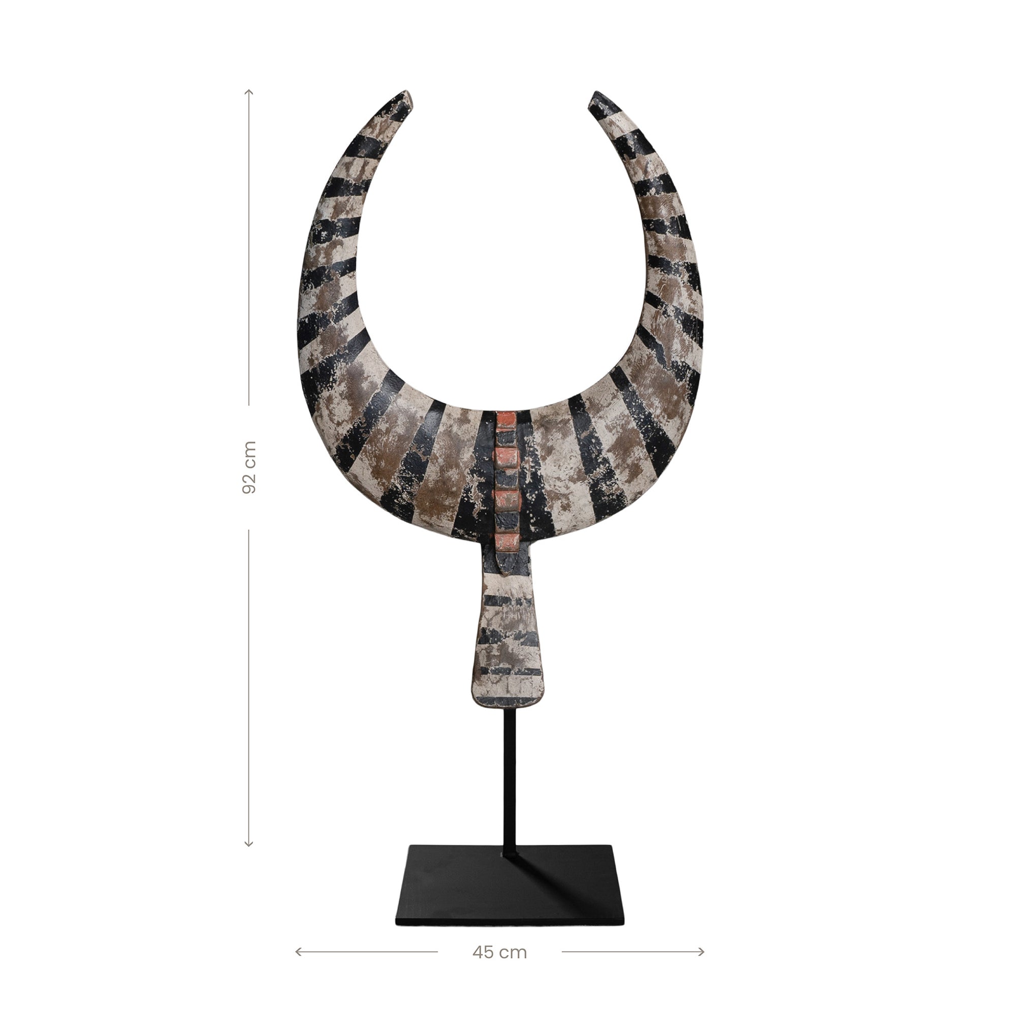 A striking decorative tribal horn sculpture with bold black and natural tones, mounted on a sleek black stand, adding an artisanal touch to modern interiors.