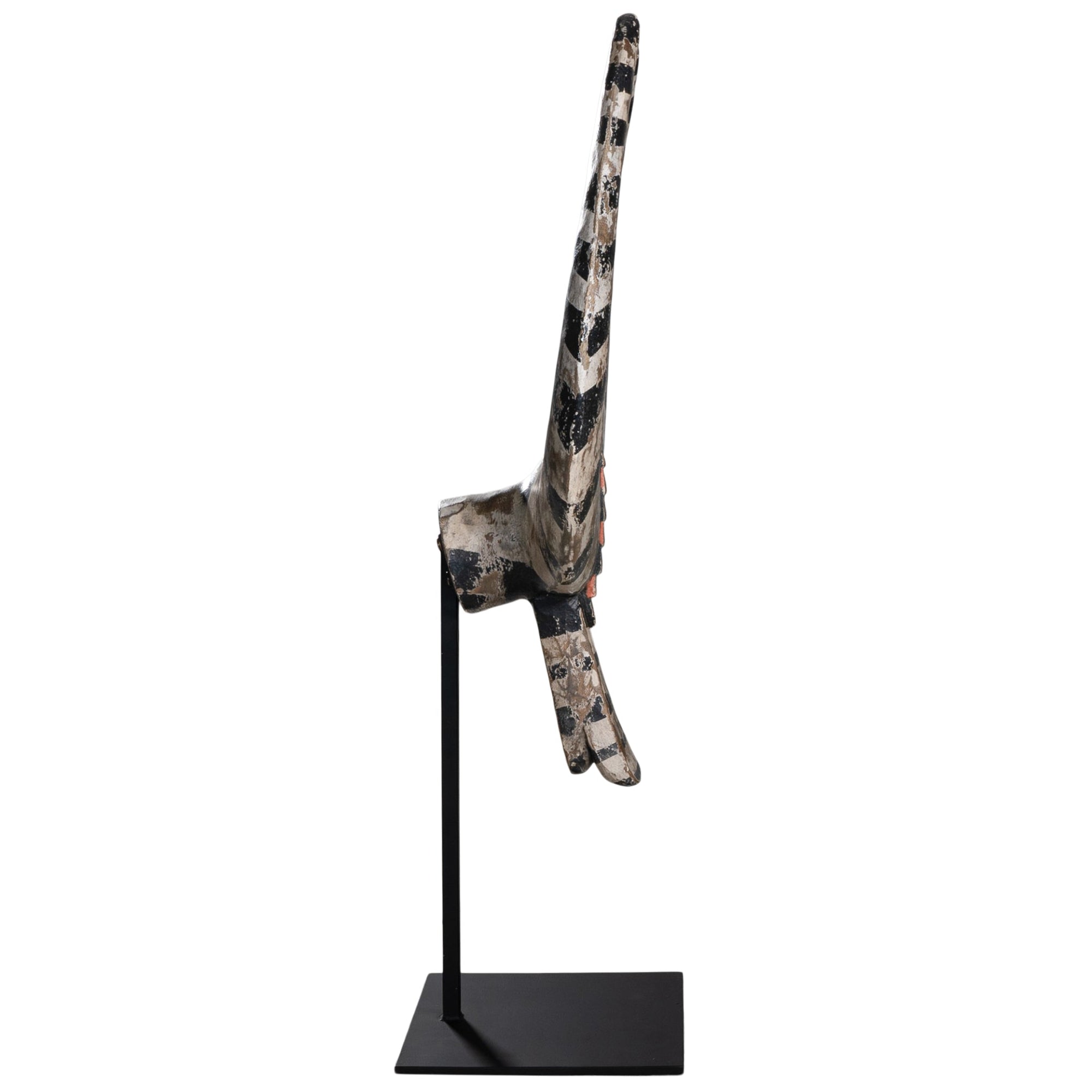 A striking decorative tribal horn sculpture with bold black and natural tones, mounted on a sleek black stand, adding an artisanal touch to modern interiors.