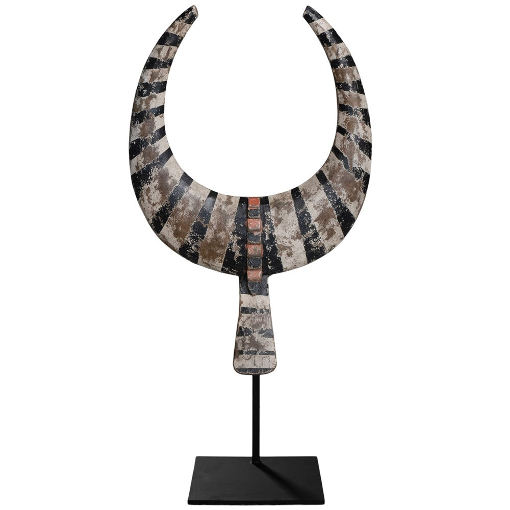 A striking decorative tribal horn sculpture with bold black and natural tones, mounted on a sleek black stand, adding an artisanal touch to modern interiors.