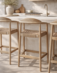 Dedon outdoor counter chair with woven rope seat and backrest, designed for relaxed alfresco dining and outdoor entertaining.