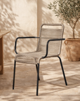 Dumo dining chair in black and natural rope styled in a sunlit mediterranean inspired australian courtyard with warm stone textures