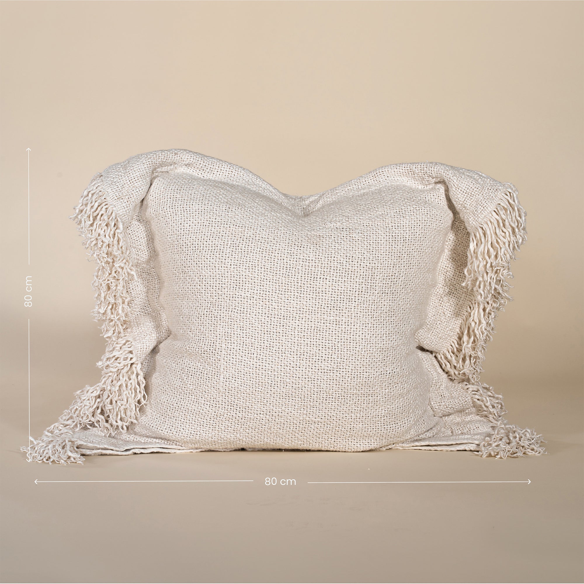 A beautifully textured handwoven linen cushion cover in a soft natural hue, featuring delicate fringe details for a relaxed, organic look. Ideal for layering on sofas or beds