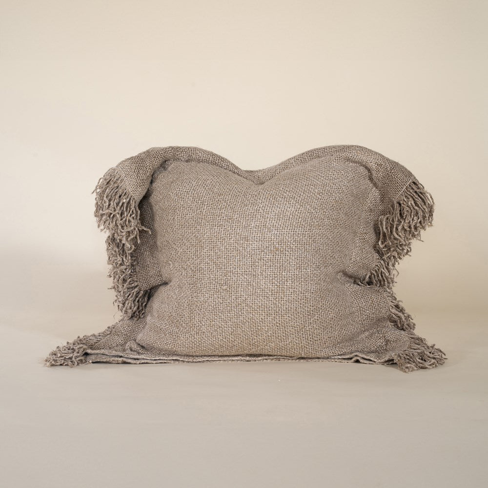A beautifully textured handwoven linen cushion cover in a soft natural hue, featuring delicate fringe details for a relaxed, organic look. Ideal for layering on sofas or beds