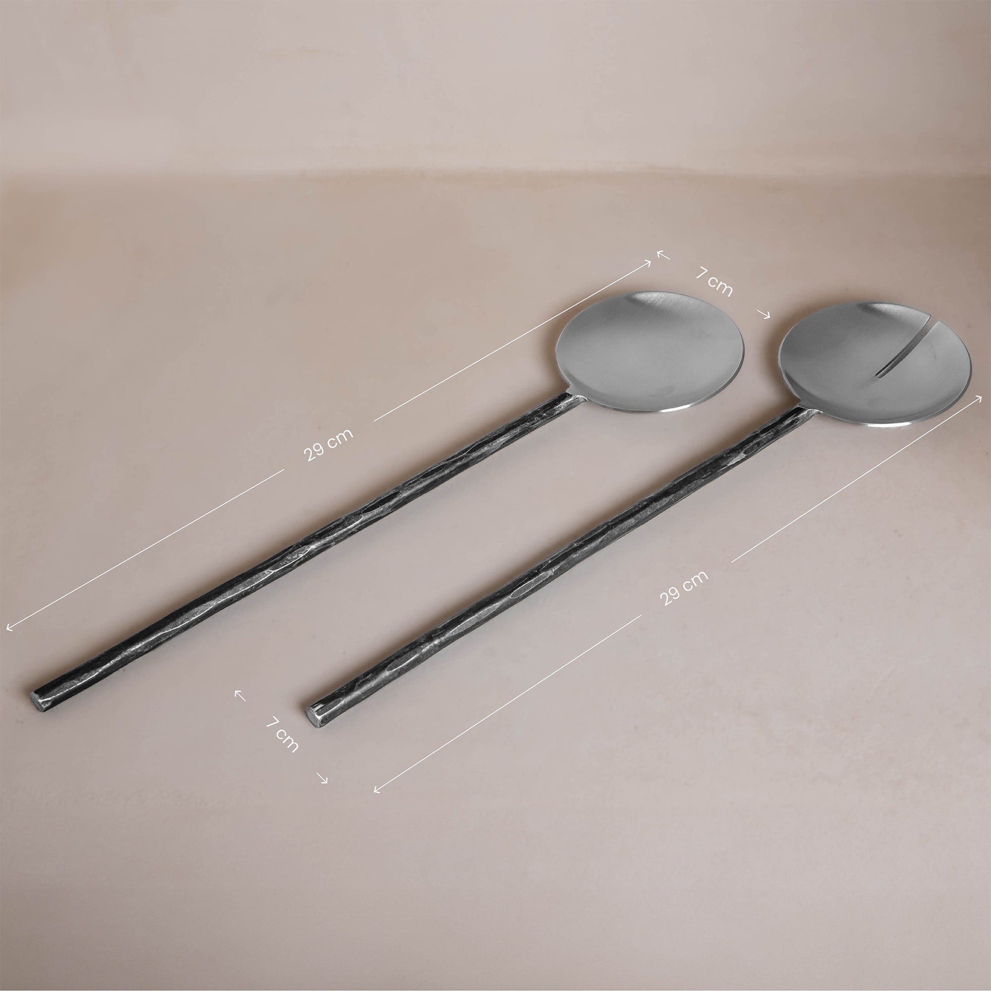 A set of handcrafted black iron salad servers from KULALA Living, featuring a modern rustic design with textured handles, elegantly presented in a gift box