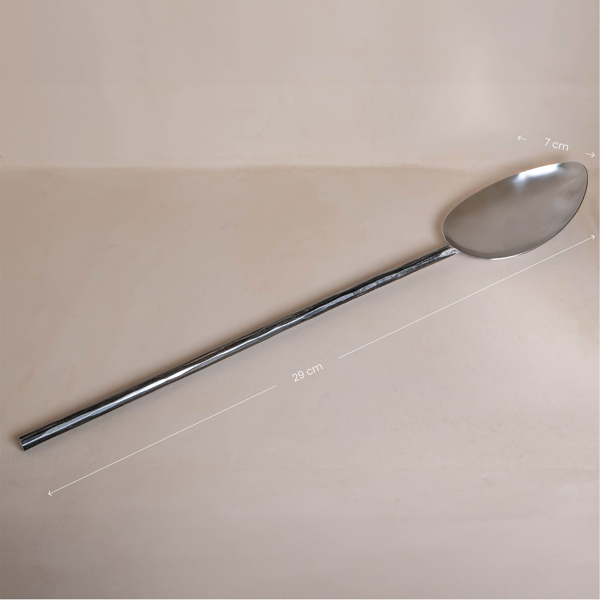 A handcrafted iron cooking spoon from KULALA Living, featuring a long black metal handle and a polished stainless steel scoop, perfect for stirring and serving with ease