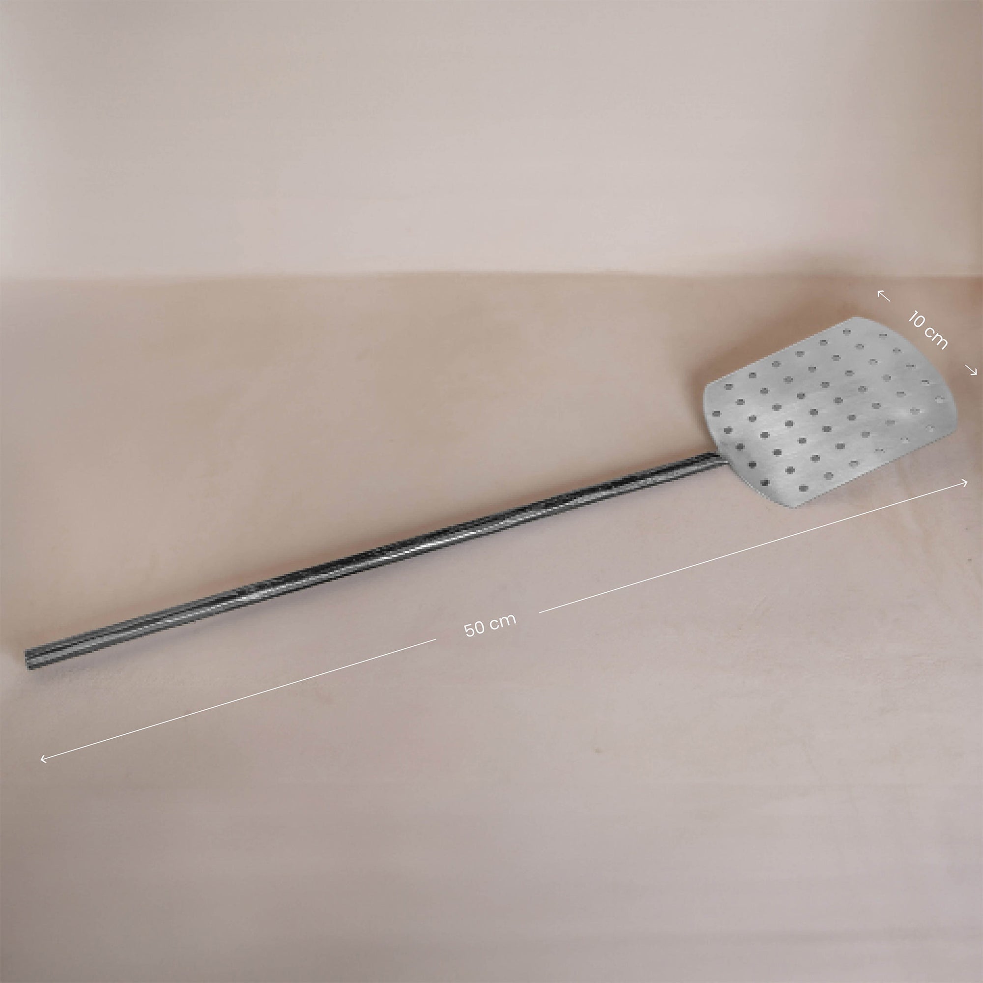 A handcrafted metal spatula from KULALA Living, featuring a perforated stainless steel paddle and a long black iron handle for effortless pizza baking and serving