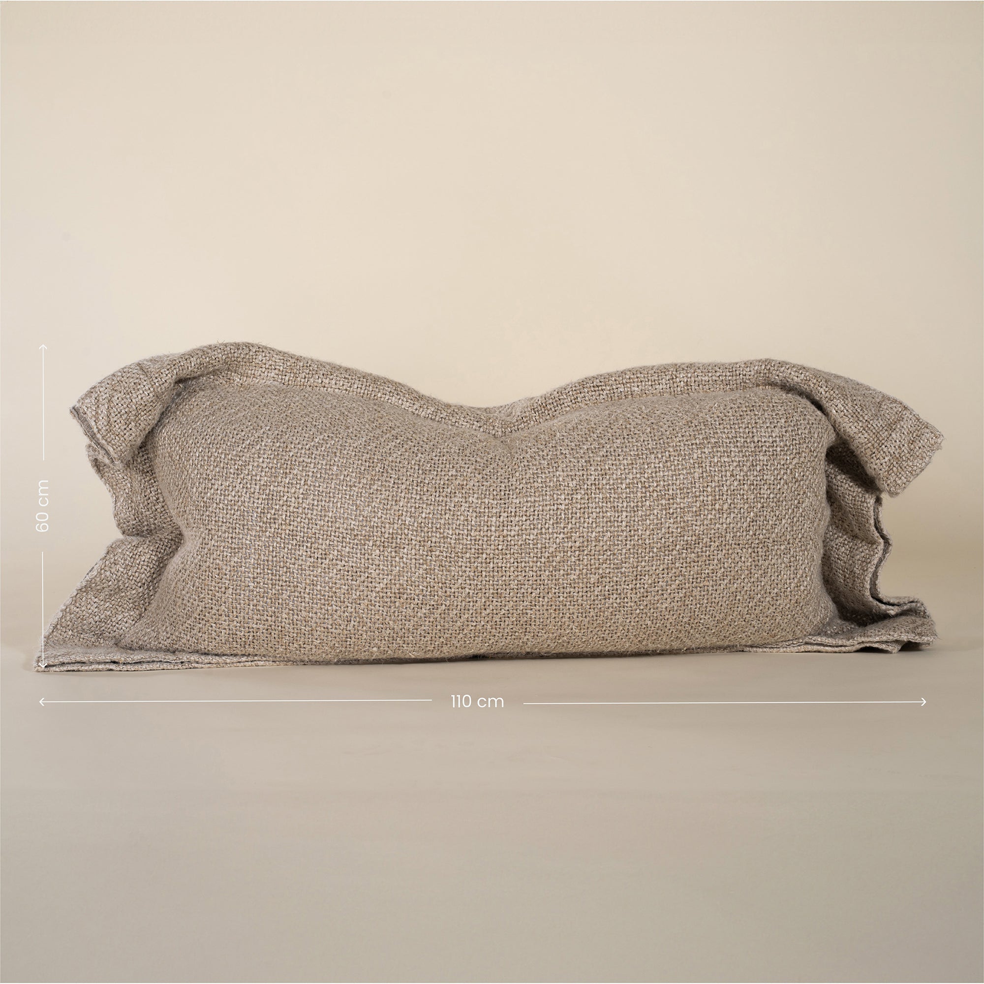A soft, handwoven linen cushion cover in a natural off-white hue, featuring a relaxed, textured finish. Perfect for adding an organic touch to any living space