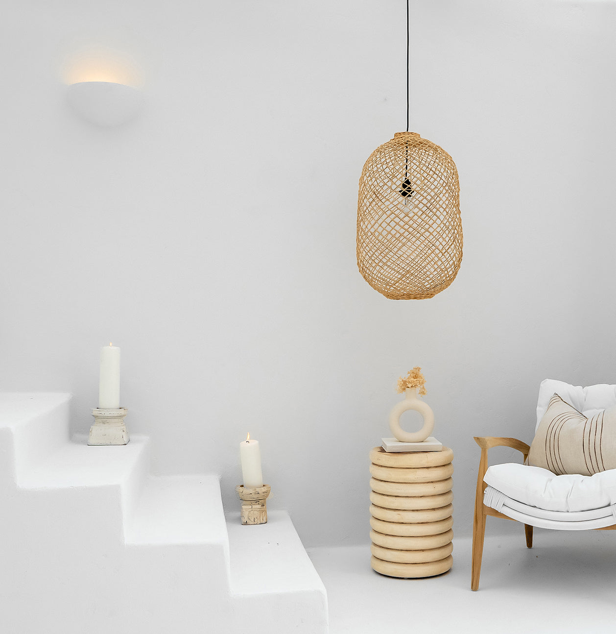 Kulala Living handwoven rattan pendant light styled in a minimalist white space, paired with natural wood furniture and soft textiles for a relaxed, coastal aesthetic
