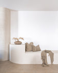 KULALA Living Katanga Vase, Sage Linen Cushion and Gaya Linen Cushion styled on a curved white built in bench in a minimalist neutral interior.