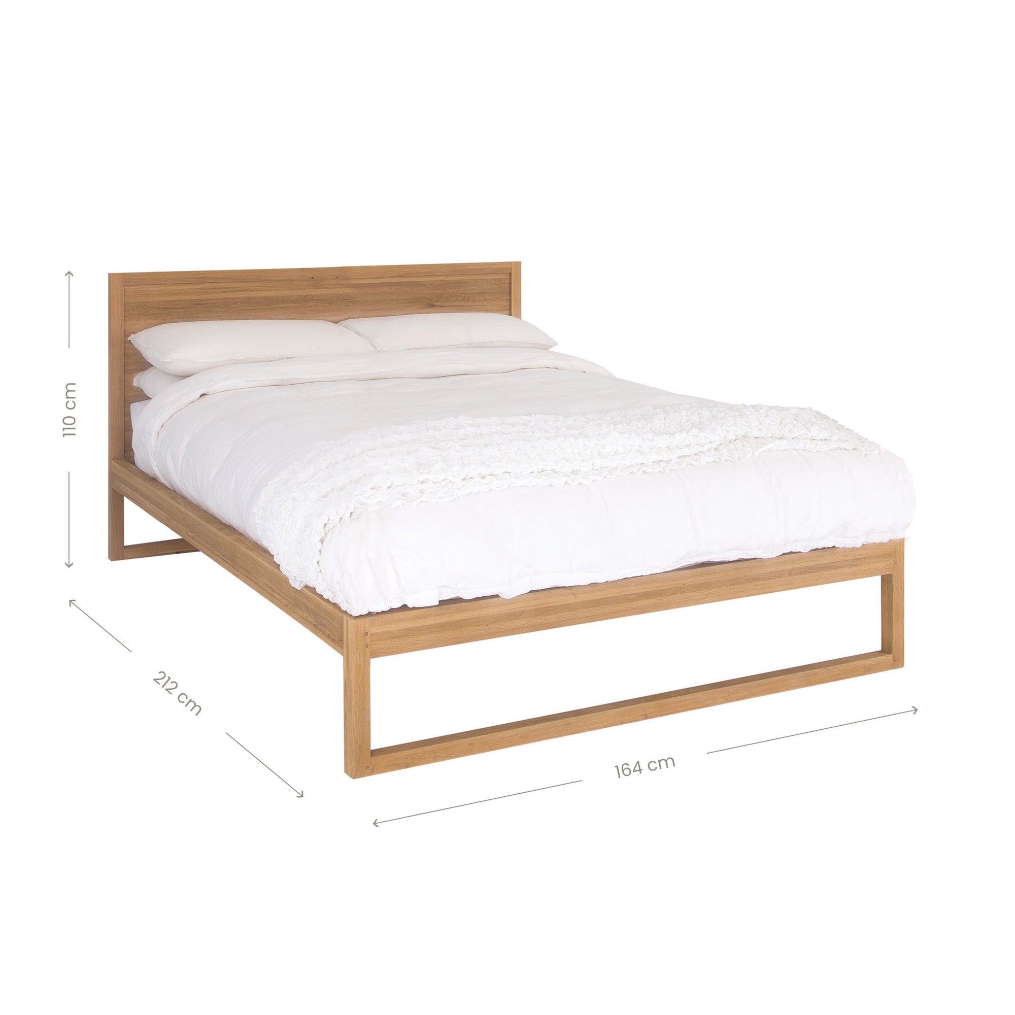 A sleek modern bed frame crafted from natural oak, featuring a minimalist open-base design. The bed is styled with crisp white linen and plush pillows, offering a refined and contemporary bedroom aesthetic
