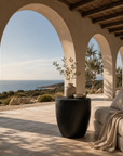 Kisiki Stool in black timber adds sculptural contrast to a relaxed coastal Mediterranean inspired terrace