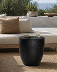 Kisiki Stool in black timber adds sculptural contrast to a relaxed coastal outdoor lounge setting