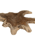Koro serving board in teak featuring natural edge detail and rich organic wood grain.