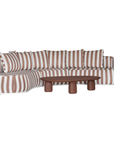 Laguna modular sofa in cinnabar stripe fabric with curved form and soft cushions on a clean background.
